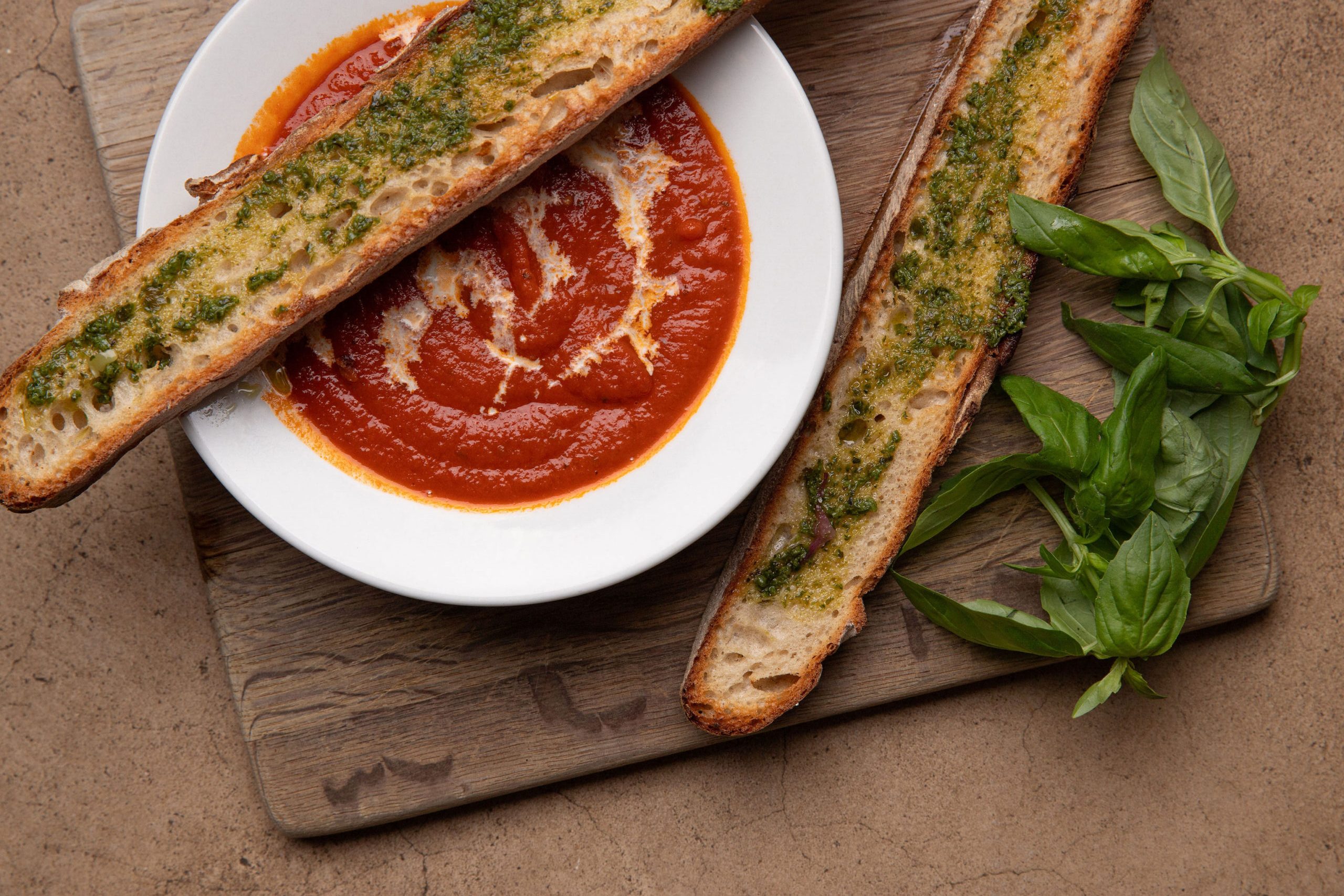 Tomato soup with home-baked pesto baguette